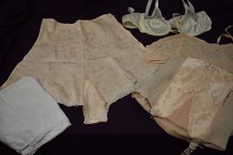 A collection of vintage underwear including lace 1930s/40s bra in pink, 1940s tap pants, white 1950s