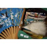 A mixed box of vintage fans, gloves and headscarves.