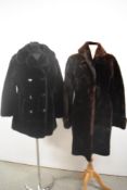 A vintage sheepskin coat in brown and a similar faux fur coat in black.
