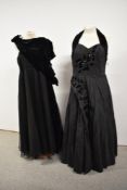 Two 1950s black evening dresses, one having appliqué velvet flowers, sequins and halter neck with