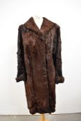 A vintage full length 1940s fur coat having contrasting Astrakhan edge to collar and cuffs.