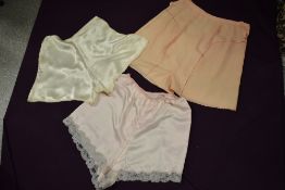 Three pairs of vintage tap pants, including 1930s pink pair with ladder work.