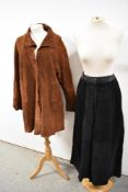 A vintage 1990s suede coat and a pair of black suede culottes.