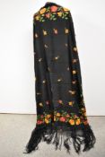 A beautiful late 19th/ early 20th century shawl having black ground with orange, red and yellow