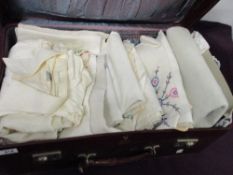 A suitcase containing mixed table linen, including embroidered examples, also included is a gents