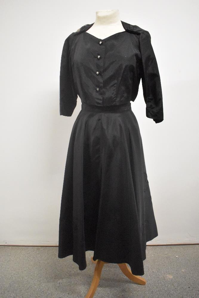 A late 1940s evening skirt having floral appliqué design and metal zip, also included in a similar