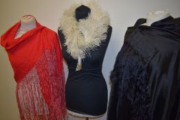 Two vintage shawls, including deeply fringed red cotton example and a feather collar or tippet.