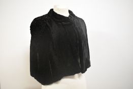 A stunning 1930s black velvet cape with raised soutache braid like detailing to shoulders and