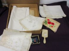 A small selection of vintage bedding, a mirror, compact and stocking case.