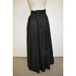 A 1940s black full length taffeta evening skirt with gathered cummerbund style waist band.