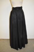 A 1940s black full length taffeta evening skirt with gathered cummerbund style waist band.