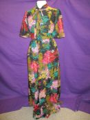 A 1960s/early 70s Quad maxi dress having vibrant floral pattern.