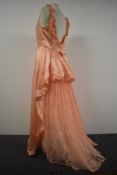 A vintage pink evening gown having peplum waist detail to back and layers of tulle lace and net.