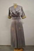 An Edwardian silk day dress in slate grey having lace panel to ruffled bodice and to sleeves, hook