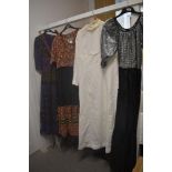 Four vintage maxi dresses, including 1960s white long sleeved dress, various styles and eras.