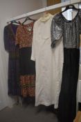 Four vintage maxi dresses, including 1960s white long sleeved dress, various styles and eras.