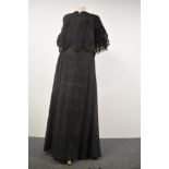 A Victorian skirt of black semi sheer wool like fabric, lined with cream cotton, and a capelet or