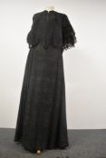 A Victorian skirt of black semi sheer wool like fabric, lined with cream cotton, and a capelet or