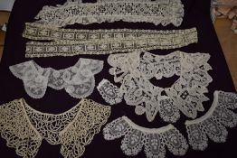 A selection of intricate antique and vintage lace collars and panels.