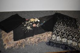 A large late 19th/early 20th century shawl having fringed edging and extensive embroidery, also