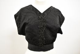 A Victorian beaded bodice, having cap sleeves and hook and eye front fastening with grosgrain