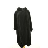 A 1950s Fenwick of Bond street Fair Lady swing coat in black velvet with shawl collar and large