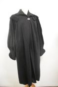 A striking 1940s black wool fully lined swing coat with wide sleeves gathering into fitted cuffs,