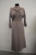 A 1940s wool crepe two piece set comprising of dress and jacket in dove grey with pink piped