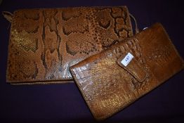 A mid century crocodile clutch bag having internal compartment with metal zip and a larger reptile