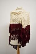 A late 19th/ early 20th century cream shawl having burgundy edging with fringing.