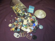 A jar full of vintage and antique buttons and buckles.