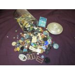 A jar full of vintage and antique buttons and buckles.