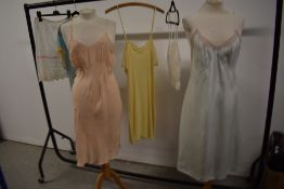 Three vintage 1940s and 50s slips including CC41, a camisole and bed jacket.