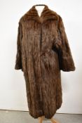 A 1950s full length squirrel coat having shawl collar and high quality lining.