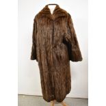 A 1950s full length squirrel coat having shawl collar and high quality lining.