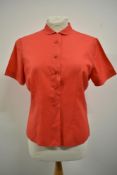 A 1950s cherry red blouse, 'Maxton regd Tricel fabric' bust size 36.