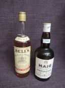 A bottle of Haig Gold Label Blended Scotch Whisky, 70% proof, 26 2/3fl and a bottle of Bells Extra