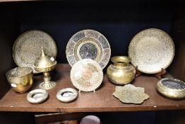 A selection of Indian brass wares including an antique plate with Hindu decoration