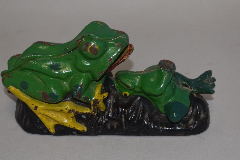 A vintage cast iron money box or bank in the form of a mechanical frog