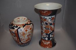 Two antique Japanese Imari wares including large trumpet form vase and lidded jar decorated with