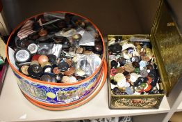 A large selection of vintage dress makers buttons and fasteners in two vintage biscuit tins