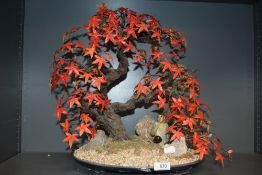 A vintage faux cherry tree with scenic base and mudman figure