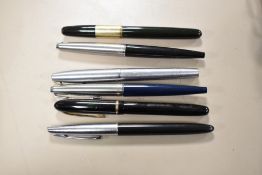 Five fountain pens and a rollerball pen. Two Parker 45 classics, A Sheaffer rollerball, a Waterman