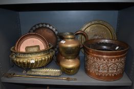 A fine selection of copper and brass wares including, lion head handle and footed planter, Arts