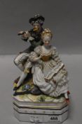 A German made porcelain lidded container with 18th century couple playing music in a Dresden style.