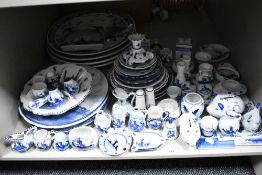 A selection of Dutch Delft wares including large chargers, plates, containers, money banks and