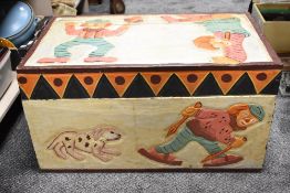 A vintage children's toy chest or trunk, having carved case with pendant border and painted clown