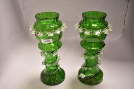 A pair of Victorian green glass mantel vase with clear twist decoration to stem. 26cm high both