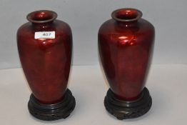 Two early 20th century Chinese guilloche and enamel worked vases both in cranberry red, one