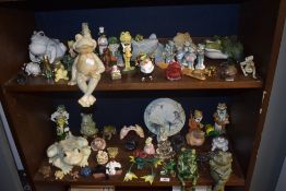 A large selection over two shelves of frog and toad themed figures ornaments and decorations